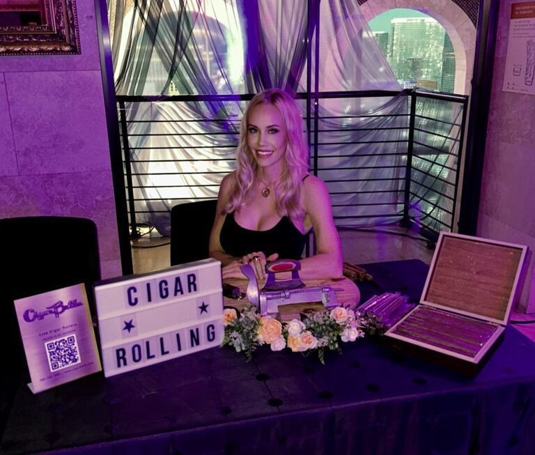 Cigar rolling artists from Cigar Bella clip and light cigars for guests.