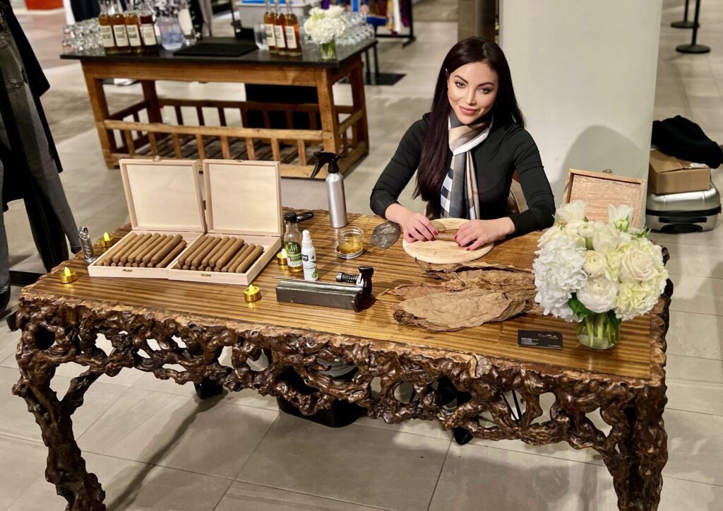 Master cigar roller, Dallas, Texas, selecting premium class tobacco leaves ready to roll.