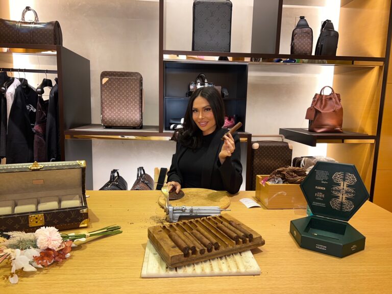 Artist from Cigar Bella hand rolling cigars at designer goods store in Houston.