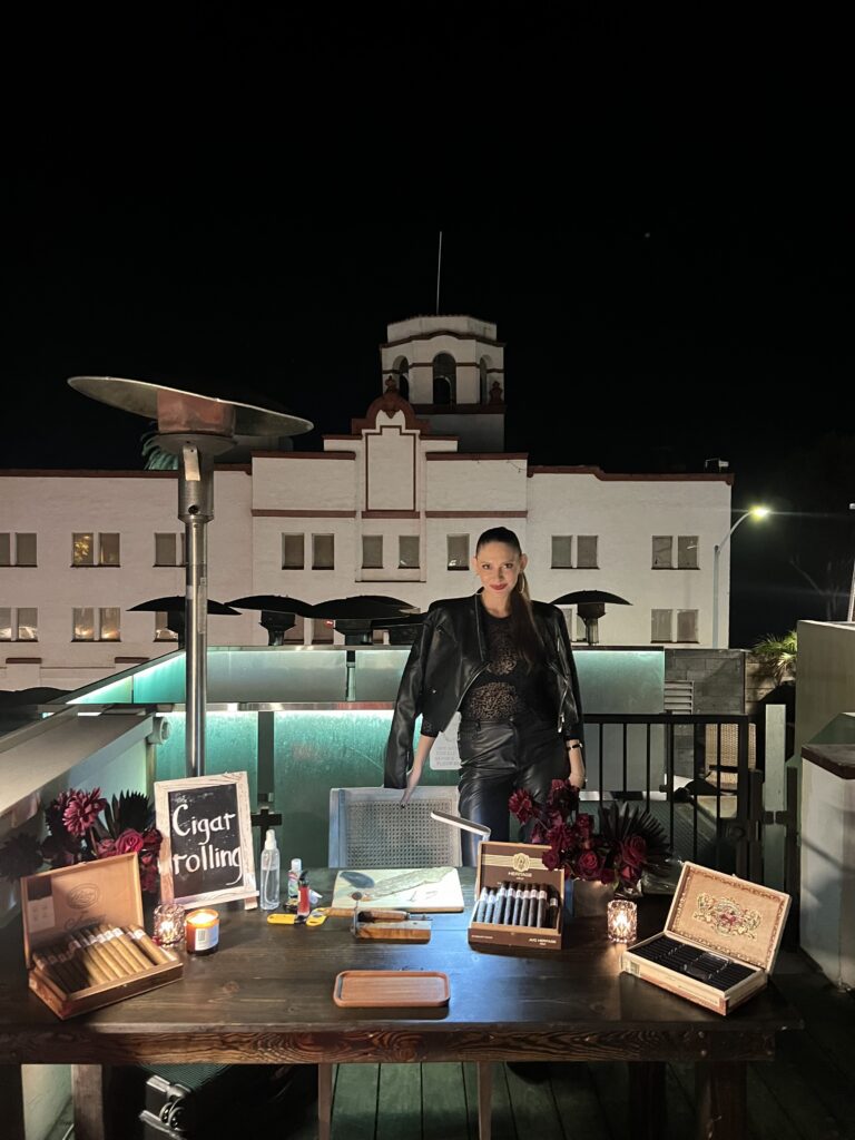 Rooftop cigar roller serving guests at Dallas event.